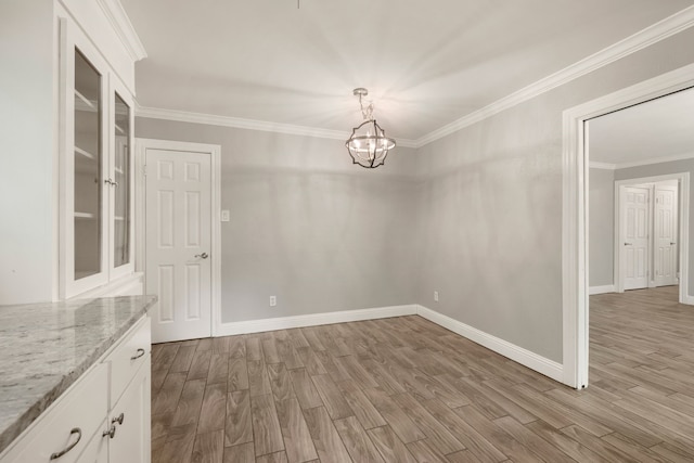 6455 Waverly Way, Fort Worth, TX 76116 - unfurnished dining area with a chandelier, wood finished floors, crown molding, and baseboards