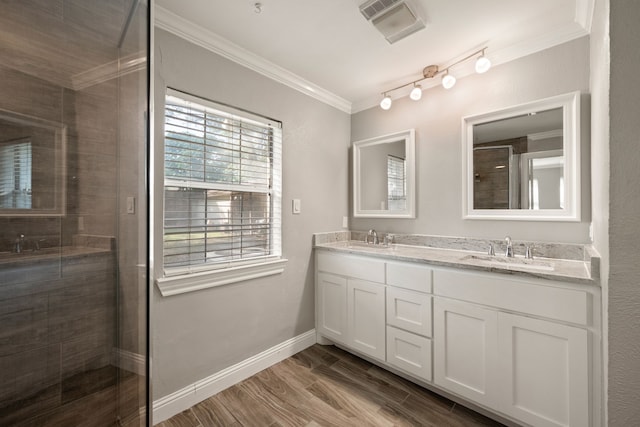 6455 Waverly Way, Fort Worth, TX 76116 - bathroom featuring tiled shower, crown molding, double vanity, wood finished floors, and baseboards