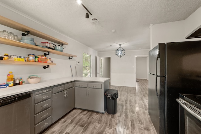 6455 Waverly Way, Fort Worth, TX 76116 - kitchen with gray cabinets, appliances with stainless steel finishes, a textured ceiling, a peninsula, and light wood-style flooring