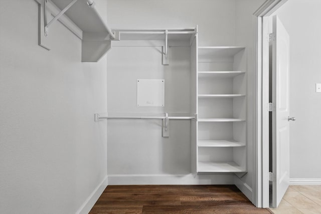 7802 Lindsey Dr, Rowlett, TX 75088 - walk in closet featuring wood finished floors