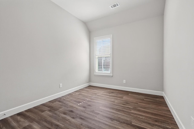 7802 Lindsey Dr, Rowlett, TX 75088 - spare room featuring dark wood-style floors, baseboards, and lofted ceiling