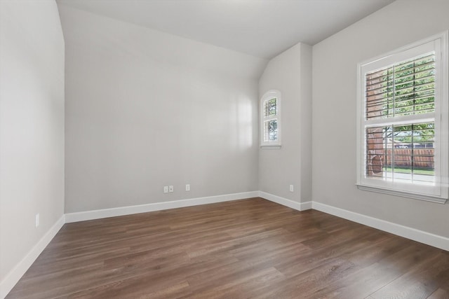 7802 Lindsey Dr, Rowlett, TX 75088 - unfurnished room with dark wood-style floors, baseboards, and vaulted ceiling