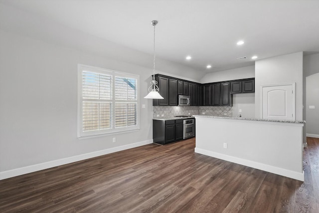7802 Lindsey Dr, Rowlett, TX 75088 - kitchen with stainless steel microwave, dark wood finished floors, backsplash, baseboards, and recessed lighting