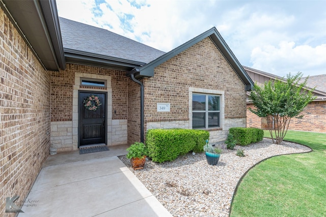 349 Mill Creek Dr, Abilene, TX 79602 - entrance to property featuring brick siding, a shingled roof, and stone siding