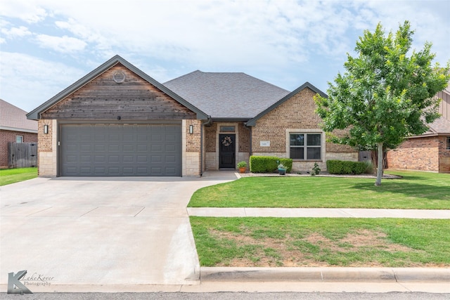 349 Mill Creek Dr, Abilene, TX 79602 - view of front of house with a garage, concrete driveway, brick siding, and a front yard