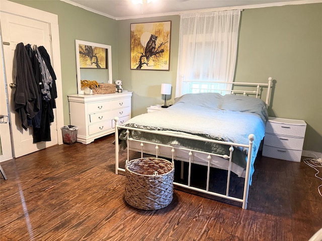 401 Ash St, Teague, TX 75860 - bedroom with ornamental molding and wood finished floors