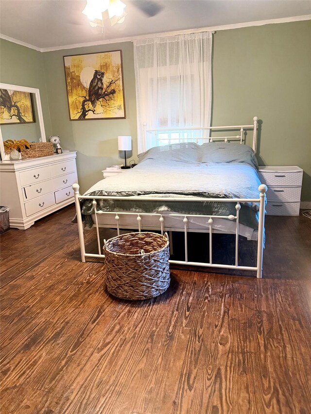 401 Ash St, Teague, TX 75860 - bedroom with wood finished floors, crown molding, baseboards, and a ceiling fan