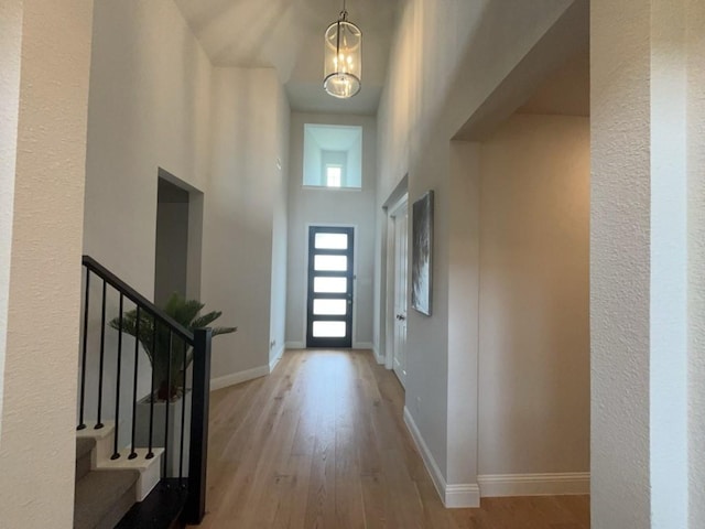 501 Upper Falls Ln, Mansfield, TX 76063 - foyer entrance featuring wood finished floors, baseboards, a chandelier, stairway, and a towering ceiling