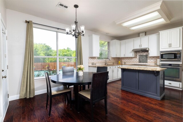 5732 Chelmsford Trl, Arlington, TX 76018 - dining area with dark wood-style flooring, a chandelier, and healthy amount of natural light