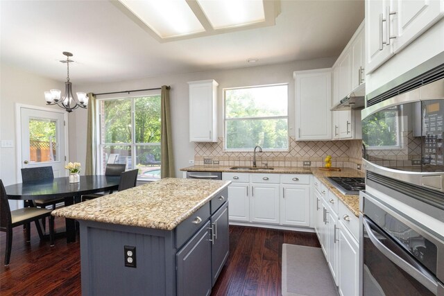 5732 Chelmsford Trl, Arlington, TX 76018 - kitchen featuring dishwasher, white cabinetry, backsplash, dark wood-style floors, and light stone counters
