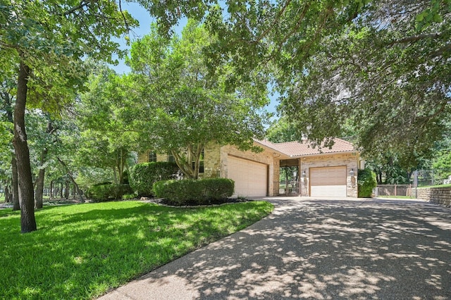 1 Hamper Ct, Trophy Club, TX 76262 - view of property hidden behind natural elements with a garage, driveway, stone siding, and a tile roof