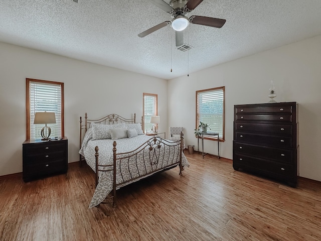 1665 Fm 2452, Corsicana, TX 75110 - bedroom with wood finished floors, a textured ceiling, and a ceiling fan