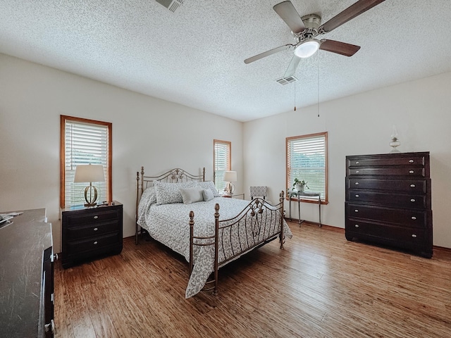 1665 Fm 2452, Corsicana, TX 75110 - bedroom with wood finished floors, ceiling fan, and a textured ceiling