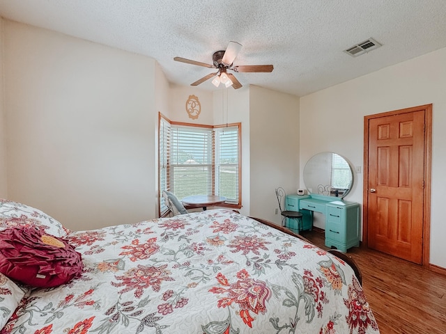 1665 Fm 2452, Corsicana, TX 75110 - bedroom with wood finished floors, a textured ceiling, and a ceiling fan