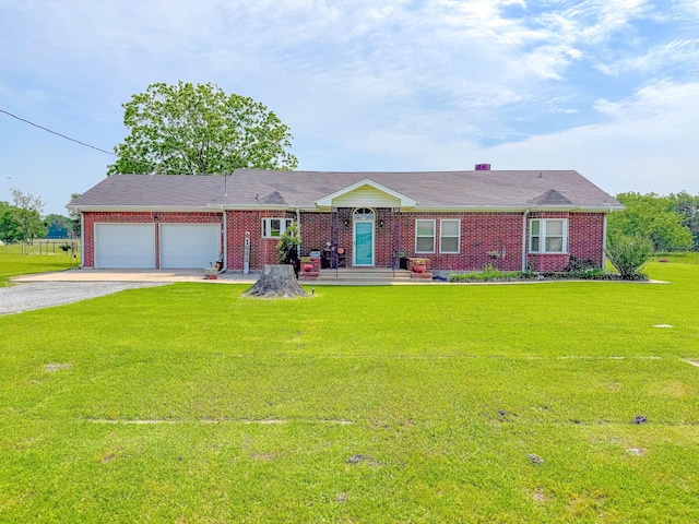 1665 Fm 2452, Corsicana, TX 75110 - view of front facade featuring gravel driveway, brick siding, an attached garage, and a front lawn