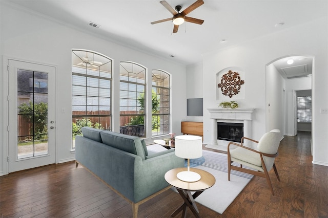7602 Bridge Water Cir, Frisco, TX 75034 - living room featuring ceiling fan, wood finished floors, a fireplace with raised hearth, crown molding, and baseboards