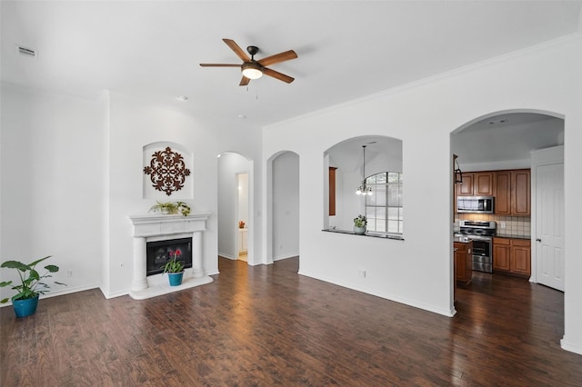 7602 Bridge Water Cir, Frisco, TX 75034 - unfurnished living room featuring ceiling fan, dark wood-style flooring, a glass covered fireplace, crown molding, and baseboards