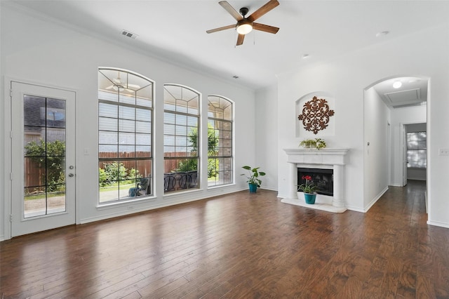 7602 Bridge Water Cir, Frisco, TX 75034 - unfurnished living room featuring a ceiling fan, wood finished floors, a fireplace with raised hearth, baseboards, and ornamental molding