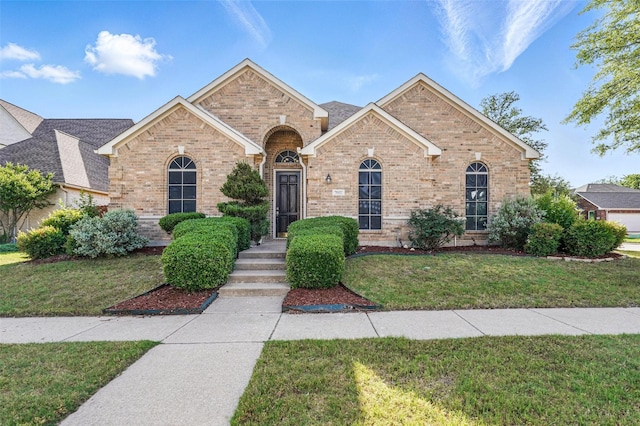 7602 Bridge Water Cir, Frisco, TX 75034 - traditional-style house featuring brick siding and a front yard
