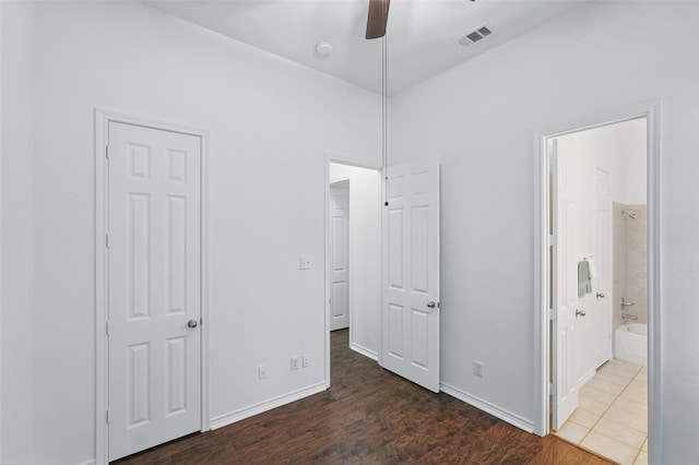 7602 Bridge Water Cir, Frisco, TX 75034 - unfurnished bedroom with wood finished floors, connected bathroom, baseboards, and a ceiling fan