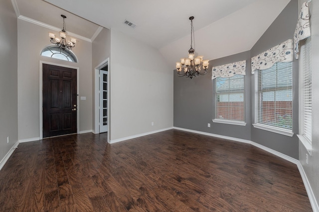 7602 Bridge Water Cir, Frisco, TX 75034 - entrance foyer with a chandelier, dark wood-style floors, lofted ceiling, baseboards, and ornamental molding