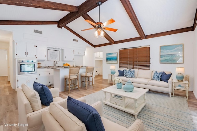 164 Harbor Dr, Gun Barrel City, TX 75156 - living room with light wood-type flooring, beam ceiling, ceiling fan, and high vaulted ceiling