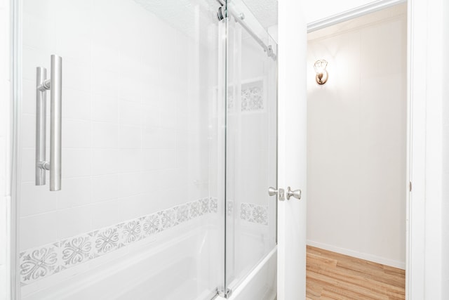 164 Harbor Dr, Gun Barrel City, TX 75156 - full bathroom featuring wood finished floors, shower / washtub combination, and baseboards