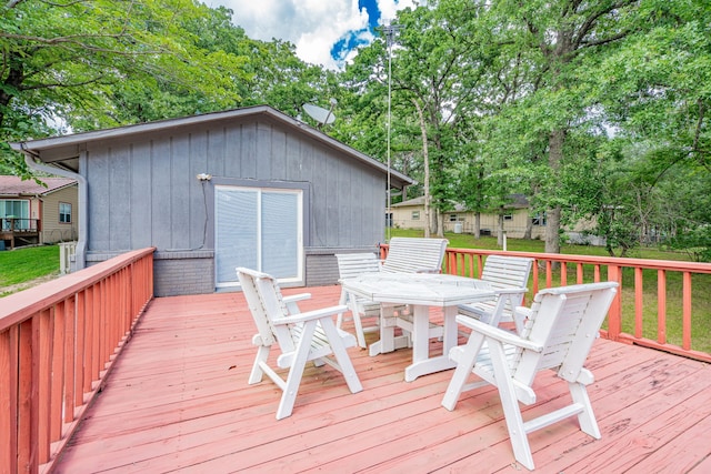 164 Harbor Dr, Gun Barrel City, TX 75156 - deck featuring outdoor dining area and view of wooded area