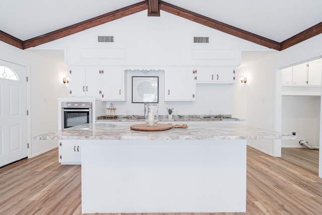 164 Harbor Dr, Gun Barrel City, TX 75156 - kitchen with stainless steel oven, white cabinetry, light wood-style floors, cooktop, and a kitchen island