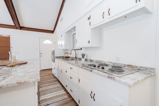 164 Harbor Dr, Gun Barrel City, TX 75156 - kitchen featuring a sink, electric cooktop, light wood finished floors, white cabinetry, and light stone counters