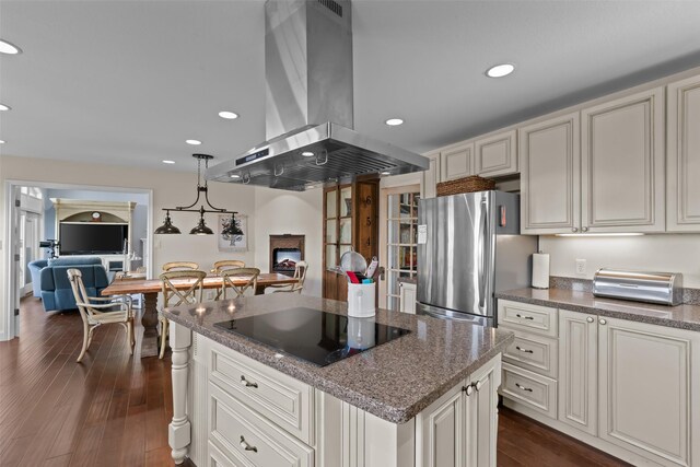 2510 River Ridge Court, Granbury, TX 76048 - kitchen featuring island exhaust hood, black electric stovetop, freestanding refrigerator, a center island, and dark wood-style flooring