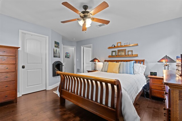 2510 River Ridge Court, Granbury, TX 76048 - bedroom with hardwood / wood-style flooring, a fireplace, baseboards, and ceiling fan
