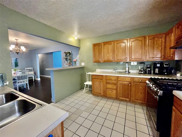 2217 Linwood Ln, Irving, TX 75061 - kitchen featuring range with gas cooktop, light countertops, a chandelier, light tile patterned floors, and a sink