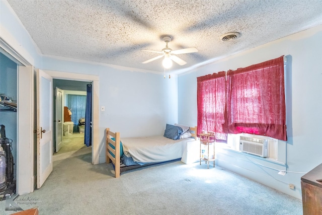 1541 S 9th St, Abilene, TX 79602 - carpeted bedroom featuring a textured ceiling, cooling unit, and a ceiling fan