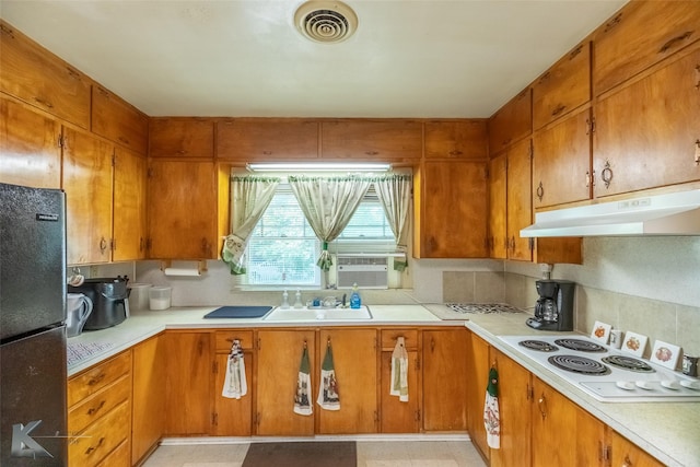 1541 S 9th St, Abilene, TX 79602 - kitchen featuring freestanding refrigerator, under cabinet range hood, a sink, and light countertops