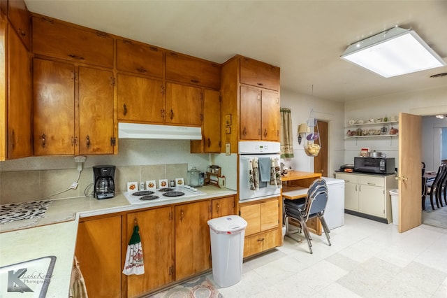 1541 S 9th St, Abilene, TX 79602 - kitchen with white appliances, under cabinet range hood, and brown cabinets