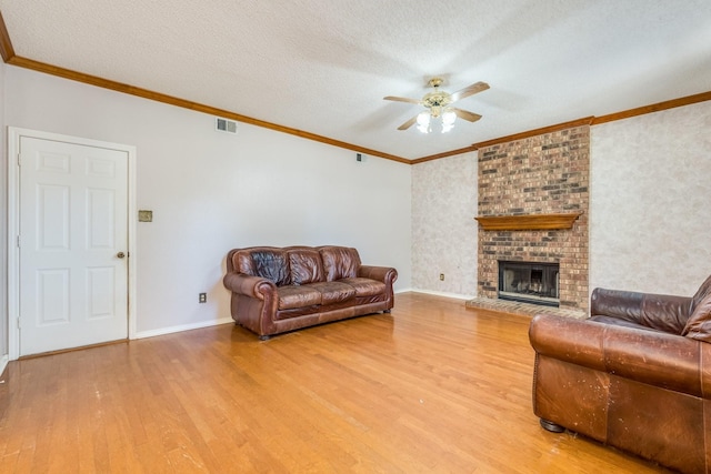 2816 Wateridge Ct, Grapevine, TX 76051 - living area featuring a ceiling fan, light wood-style flooring, crown molding, baseboards, and a fireplace