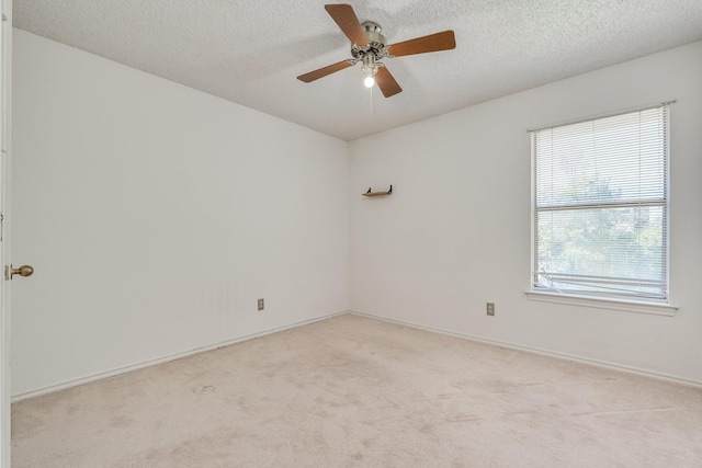 2816 Wateridge Ct, Grapevine, TX 76051 - spare room featuring light colored carpet, a ceiling fan, a textured ceiling, and baseboards