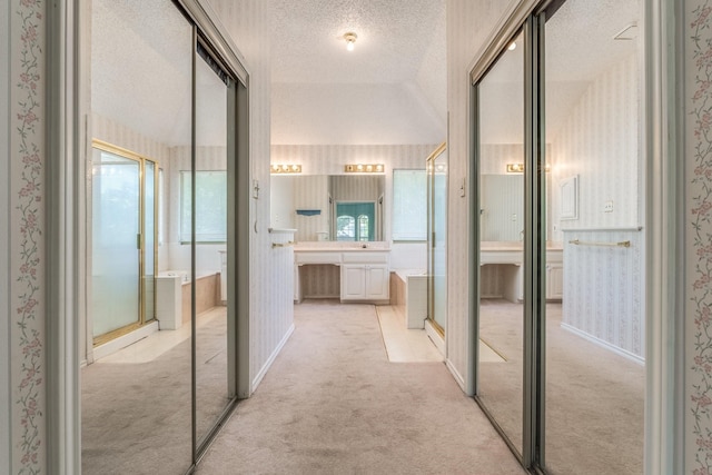 2816 Wateridge Ct, Grapevine, TX 76051 - hall with wallpapered walls, a textured ceiling, and light carpet