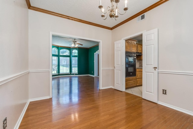 2816 Wateridge Ct, Grapevine, TX 76051 - spare room featuring crown molding, light wood-style floors, a chandelier, a textured ceiling, and baseboards