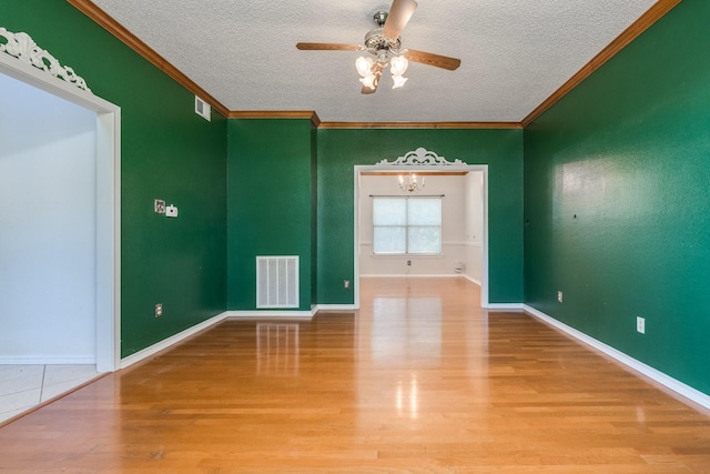 2816 Wateridge Ct, Grapevine, TX 76051 - empty room with a textured ceiling, wood finished floors, a ceiling fan, ornamental molding, and baseboards