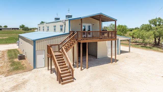 200 County Road 129, Stephenville, TX 76401 - back of property with stairs, a deck, a carport, french doors, and driveway