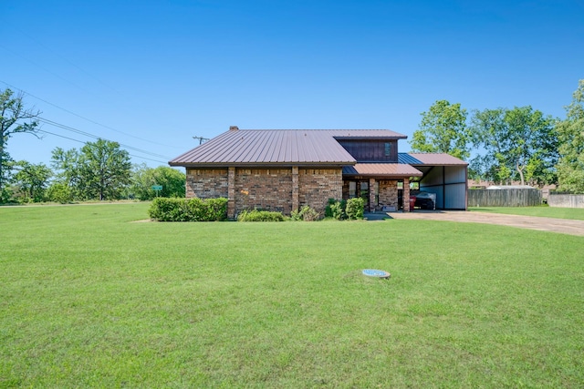 905 W 11th, Clarksville, TX 75426 - view of front facade featuring concrete driveway, an attached carport, and metal roof
