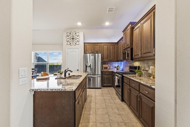 403 Woodbine Dr, Sherman, TX 75092 - kitchen featuring stainless steel appliances, backsplash, light stone counters, a sink, and recessed lighting