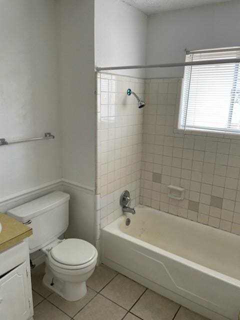 9925 Kittyhawk Ln, Dallas, TX 75217 - bathroom featuring tile patterned floors, vanity, toilet, and tub / shower combination