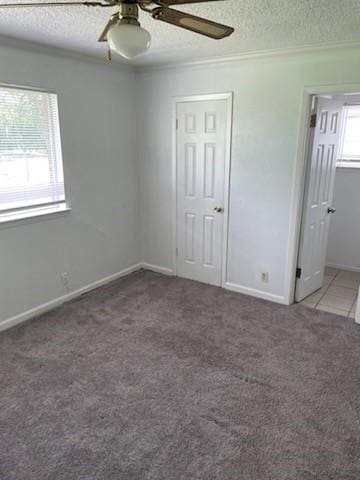 9925 Kittyhawk Ln, Dallas, TX 75217 - unfurnished bedroom with carpet, crown molding, a textured ceiling, a ceiling fan, and baseboards