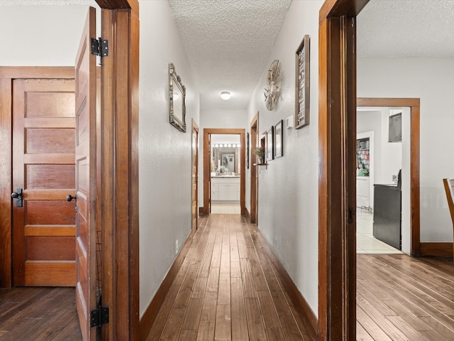 202 S Wood St, Cleburne, TX 76033 - hall featuring a textured ceiling, hardwood / wood-style floors, and baseboards