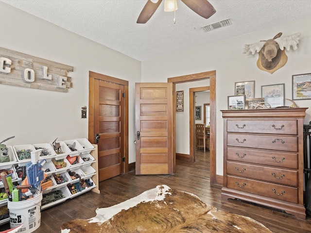 202 S Wood St, Cleburne, TX 76033 - bedroom featuring hardwood / wood-style flooring, a textured ceiling, and ceiling fan