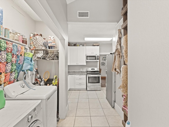 202 S Wood St, Cleburne, TX 76033 - washroom with independent washer and dryer and light tile patterned flooring
