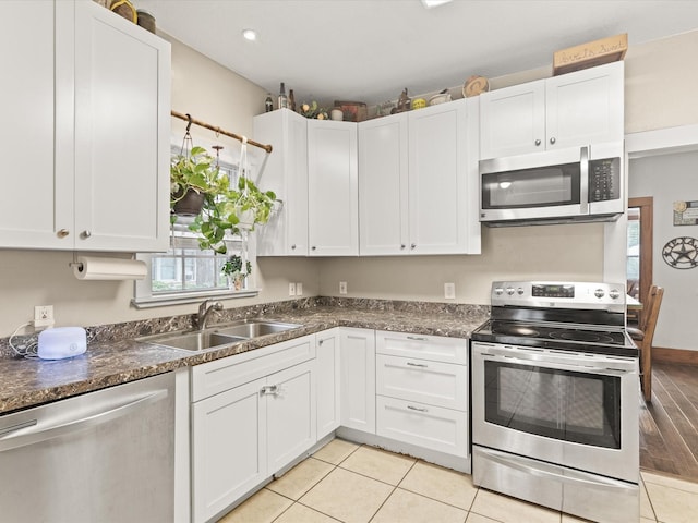 202 S Wood St, Cleburne, TX 76033 - kitchen featuring stainless steel appliances, a sink, white cabinetry, and plenty of natural light